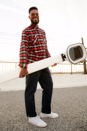 Photo of a man carrying a portable photo booth.